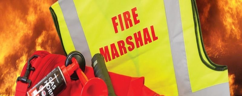Fire marshal in a hi-vis fire marshal vest with fire safety equipment